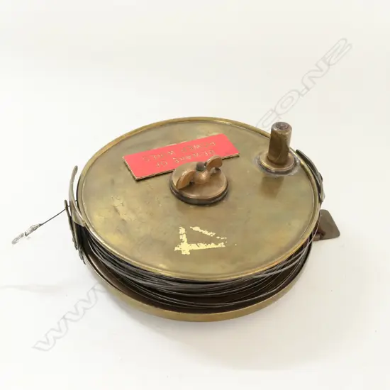 BRASS 6¼" REEL WITH FINE STEEL 'FISH TAPE' marked W. LITTLEJOHN & SON, WELLINGTON
